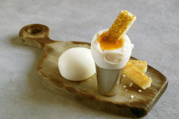 Breakfast. eggs soft-boiled on a gray background.