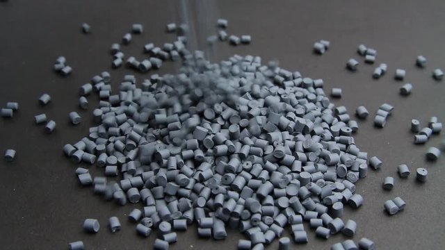 Plastic pellets spilling on background .Polymeric dye ,a colorant for plastics. Plastic resin