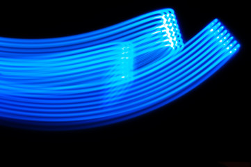 Blue neon strip lights against black background. Digital texture