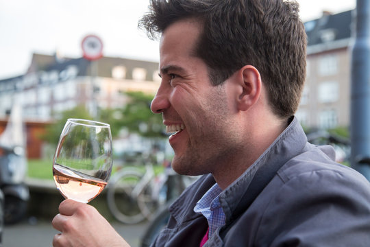 Young man holding a glass of wine