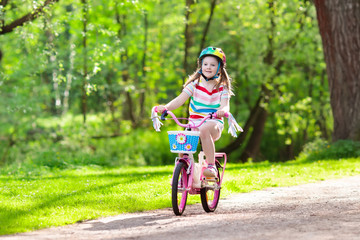 Child on bike. Kids ride bicycle. Girl cycling.