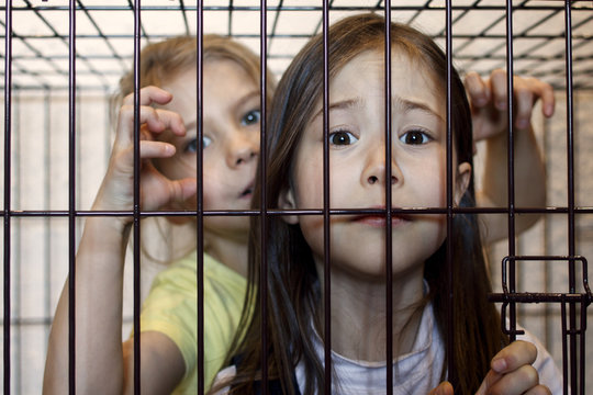 Two girls locked in an iron cage. Child crime