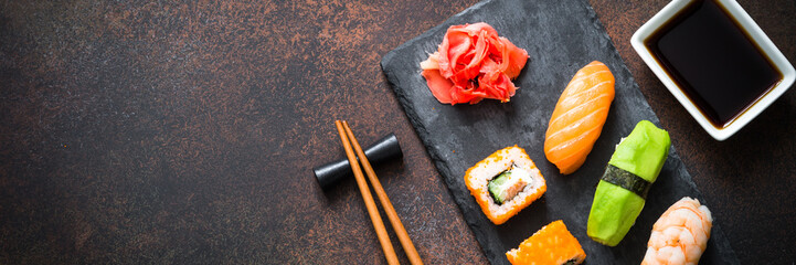 Sushi and sushi roll set on stone table top view