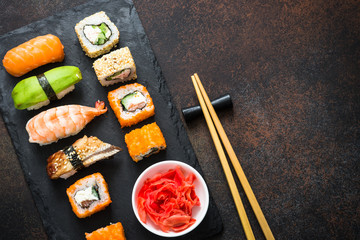 Sushi and sushi roll set on stone table top view