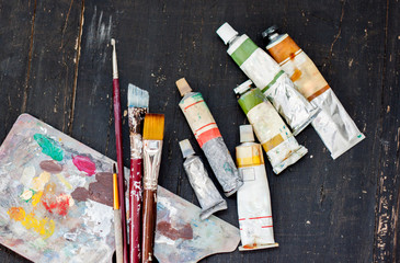 Artist paint brushes, palette and color tubes