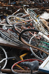 old broken bicycles in a pile of metal and junk vintage rusted scrap prices trash