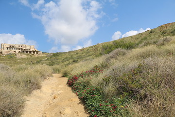 Hiking trail around Ghajn Tuffieha Bay at the Mediterranean sea in Malta 
