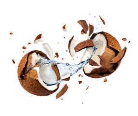 Coconut explodes into pieces on white background