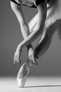 Young beautiful ballerina is posing in studio
