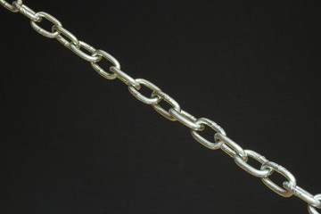 Strong silver chain on black background concept