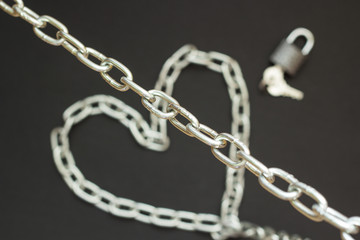 Silver chain on black background, concept strong love