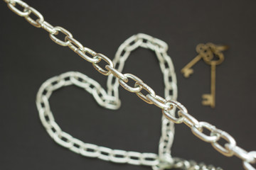 Fototapeta na wymiar Silver chain on black background, concept strong love