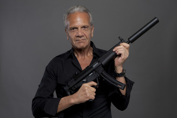 Senior hitman with automatic rifle