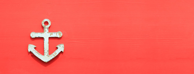 Anchor symbol on red aged board. Space for text, banner. © viperagp