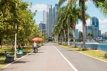 public park at ocean promenade and city skyline background 