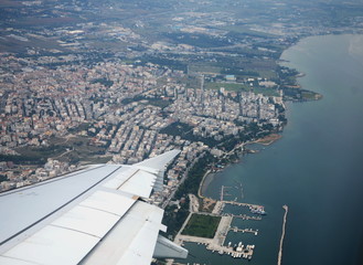 The Greek city of Thessaloniki from the airplane. You can see the silvery wing of the aircraft