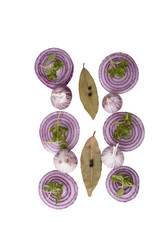 Top view. Slices of red onion, garlic, bay leaves with pepper and basil