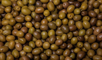 Shiny green olives background. Healthy fresh food. Closeup view.