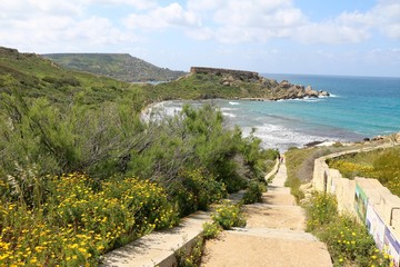 Fototapeta na wymiar Steps to Ghajn Tuffieha Bay at the Mediterranean sea in Malta