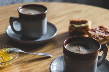 Breakfast with two coffe cups and cakes, jam. Top view