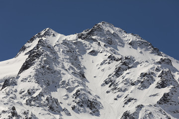 Snow-covered, fresh white mountain peak in the Alps of Switzerland