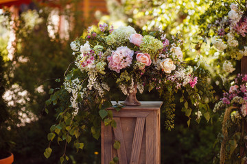 Fototapeta na wymiar Wedding decoration ceremony. Fresh flowers in vases