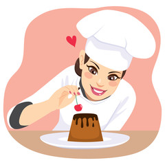 Beautiful young chef woman decorating chocolate dessert with cherry