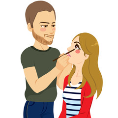 Young handsome male makeup artist working applying eyeliner on beautiful attractive woman eye