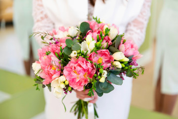 Beautiful wedding bouquet of flowers in bride’s hands