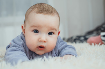 Portrait of an adorable girl lying on her belly close-up portrait