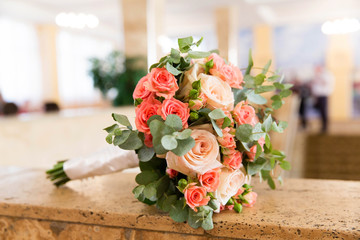Beautiful bridal bouquet of different flowers with eucalyptus leaves