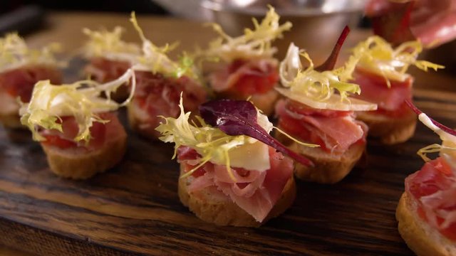 Completion of the cook's work on the production of Spanish tapas. The decoration is ready tapas greens.Ready tapas closeup.