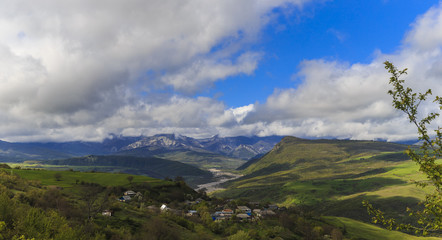 A small village in the mountains on the banks of the river in the spring
