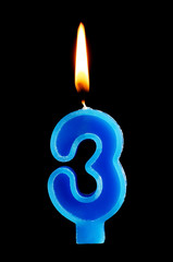 Burning birthday candle in the form of 3 three figures for cake isolated on black background. The concept of celebrating a birthday, anniversary, important date, holiday, table setting