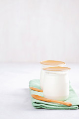 Industrial natural yogurt in plastic cans. Healthy and fast breakfast concept