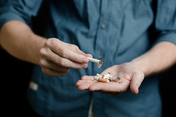 man breaks cigarettes in his hands. concept no Smoking