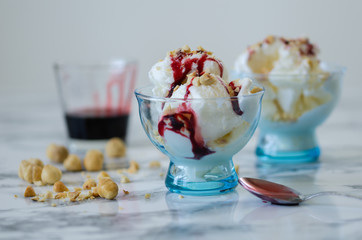 Vanilla ice cream in blue bowl,on white background,side view