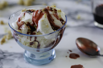 Vanilla ice cream in blue bowl,on white background,top view