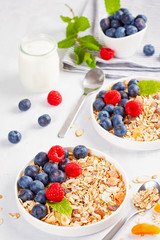 Homemade granola or oatmeal muesli with nuts, dried fruits and fresh berries. Healty diet breakfast, vegeterian food concept