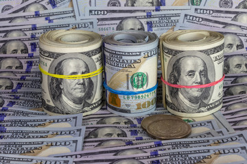 roll of cash against the background of other currencies