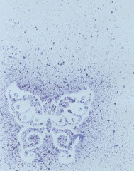 Butterfly in watercolor spray on a blue background