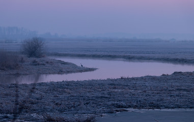 sunrise above the spring, frozen river 