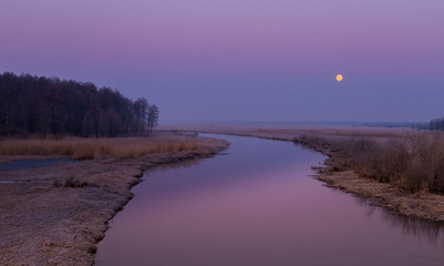 sunrise above the spring, frozen river 