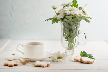 Tea with flowers and biscuits.