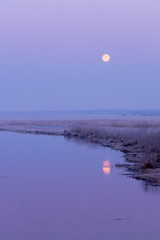 sunrise above the spring, frozen river 