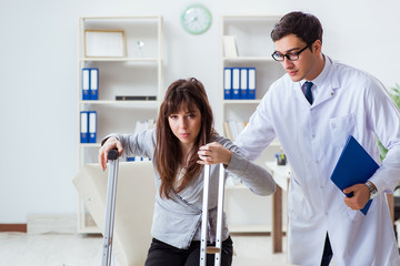 Doctor examining patient with broken leg