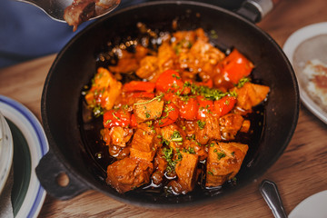 Delicious meat in a frying pan on the table