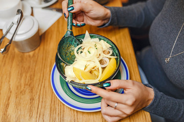 Woman eating asian traditional local cuisine soup in restaurant
