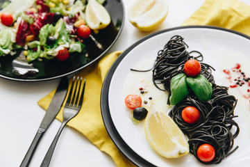 Black spaghetti with basilica and tomatoes