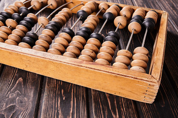 Vintage abacus on wooden background